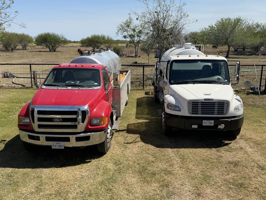 The two OnePump Septic Service vacuum trucks parked on ranch land near Victoria, Texas